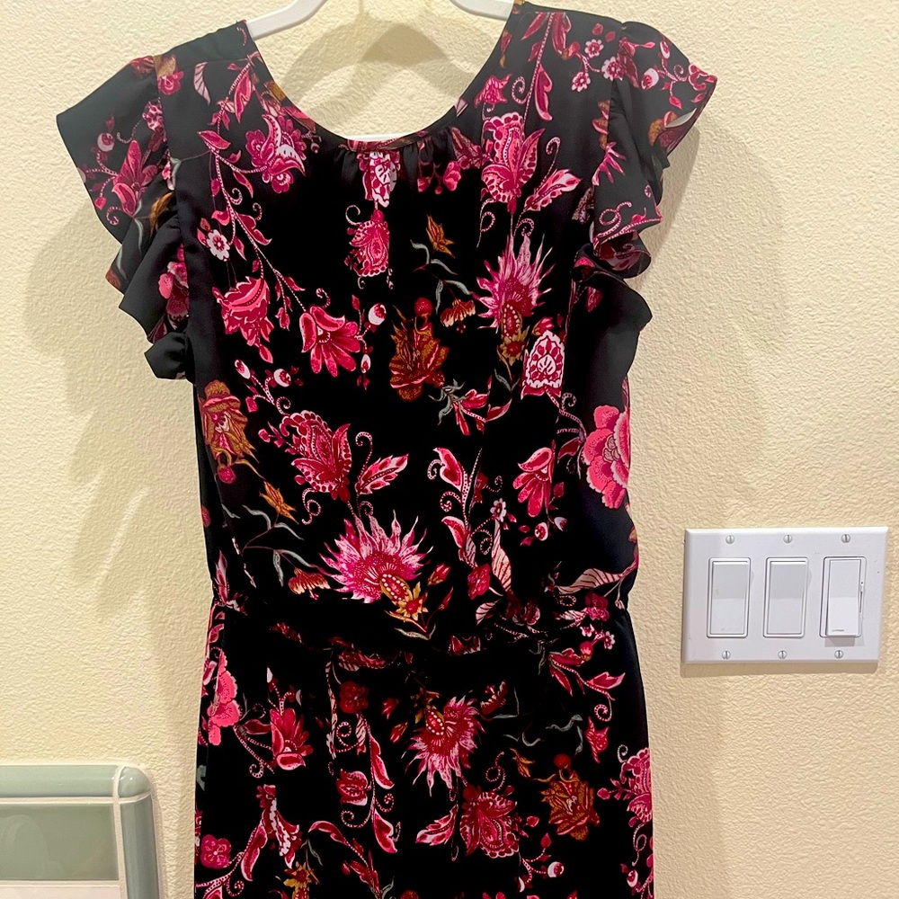 Pretty black peekaboo front solid on the back dress with flowers all over it.